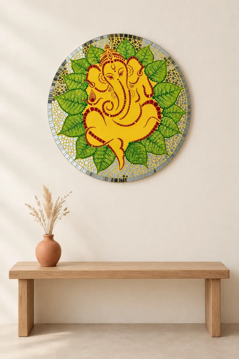 Pipal Leaf Ganesha hanging on a plain wall above a wooden bench
