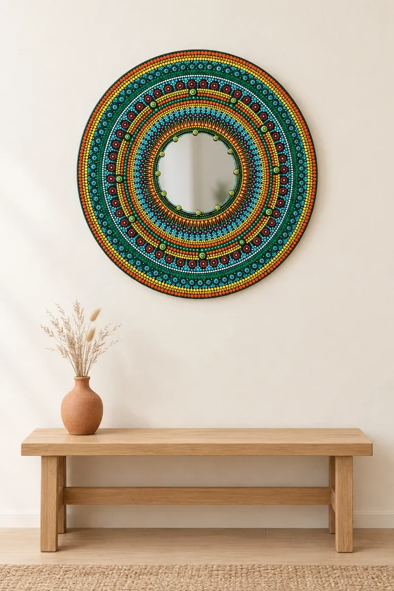 Marigold Mirror hanging on a plain wall above a wooden bench