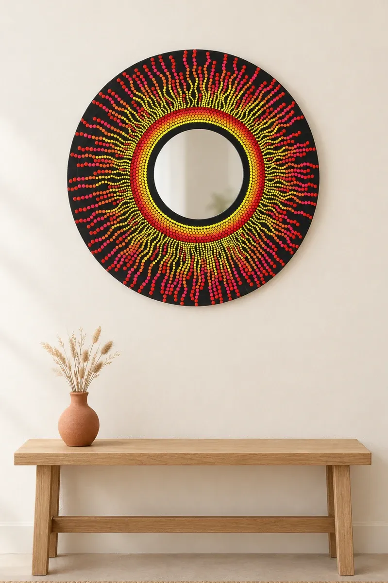 Solar Flare Mirror, 20 inches, hanging above a wooden bench